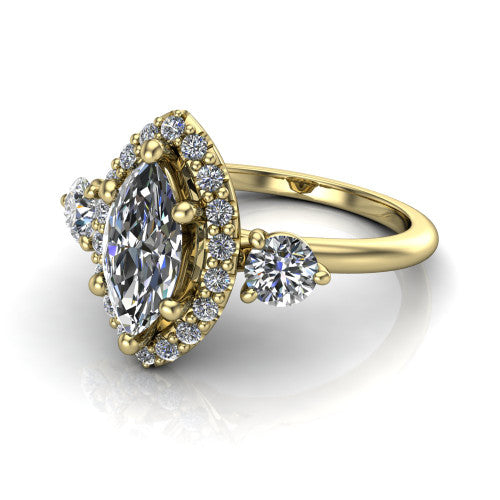 Carol marquise three stone halo engagement ring in 18K Yellow Gold, three-quarter perspective showing the marquise center in a squared pav&eacute; halo flanked by two round side stones above a plain band