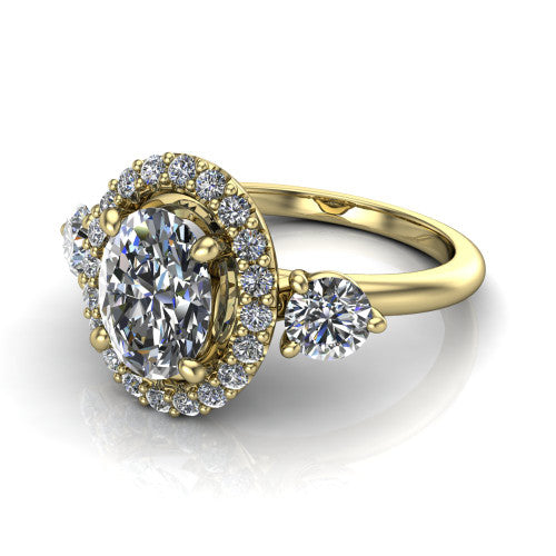 Carol oval three stone halo engagement ring in 14K Yellow Gold, three-quarter perspective showing the oval center in a squared pav&eacute; halo flanked by two round side stones above a plain band