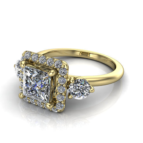 Carol princess three stone halo engagement ring in 18K Yellow Gold, three-quarter perspective showing the princess center in a squared pav&eacute; halo flanked by two round side stones above a plain band