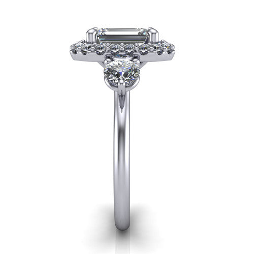 Carol emerald three stone halo engagement ring in 18K White Gold, side profile showing the plain polished band and the three-stone halo head in profile