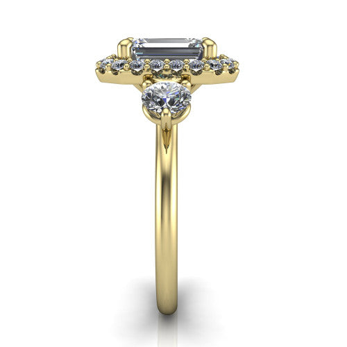 Carol emerald three stone halo engagement ring in 18K Yellow Gold, side profile showing the plain polished band and the three-stone halo head in profile
