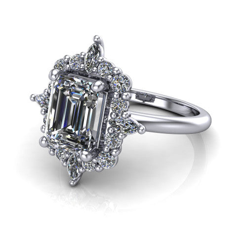 Frances emerald vintage halo engagement ring in Platinum, three-quarter perspective showing the emerald center in a marquise and round starburst halo above a plain band