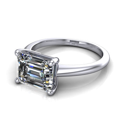 Avery emerald classic solitaire engagement ring in 14K White Gold, three-quarter perspective showing the emerald center on claw prongs above a plain polished band