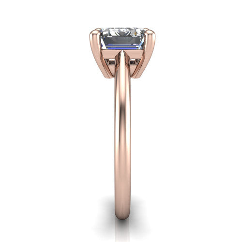 Avery emerald classic solitaire engagement ring in 14K Rose Gold, side profile showing the smooth polished band and the open basket beneath the emerald center