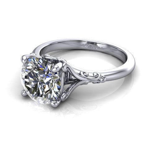 Dorothy round vintage solitaire engagement ring in 18K White Gold, three-quarter perspective showing the round center on claw prongs above a plain band with vintage filigree scrollwork