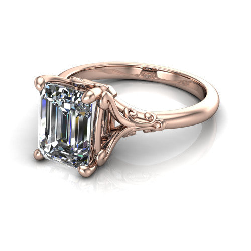 Dorothy emerald vintage solitaire engagement ring in 18K Rose Gold, three-quarter perspective showing the emerald center on claw prongs above a plain band with vintage filigree scrollwork
