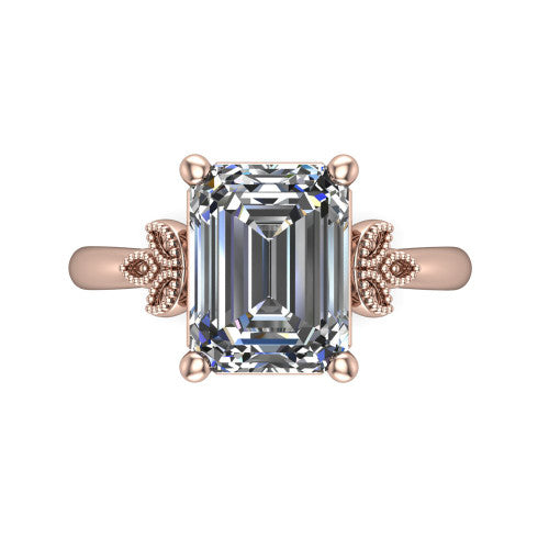 Athena emerald vintage solitaire engagement ring in 14K Rose Gold, top-down view showing the emerald solitaire center and the fleur-de-lis filigree flanking the head