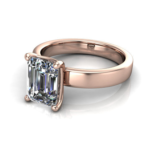 Louise emerald classic solitaire engagement ring in 18K Rose Gold, three-quarter perspective showing the emerald center on claw prongs above a wide flat polished band