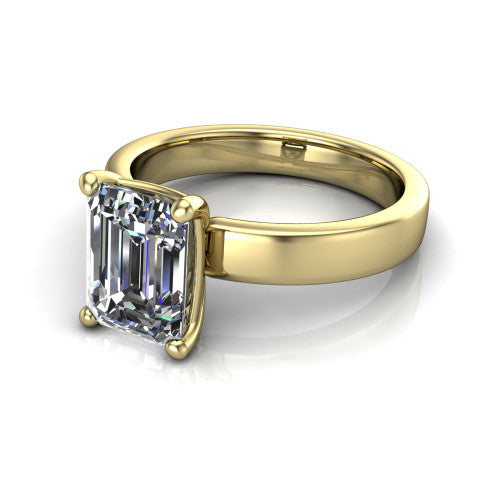 Louise emerald classic solitaire engagement ring in 18K Yellow Gold, three-quarter perspective showing the emerald center on claw prongs above a wide flat polished band