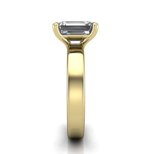 Louise emerald classic solitaire engagement ring in 18K Yellow Gold, side profile showing the substantial flat polished band and the open basket beneath the emerald center