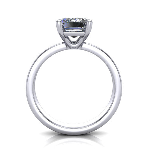 Louise emerald classic solitaire engagement ring in Platinum, through-finger front profile showing the emerald center raised above the wide flat band