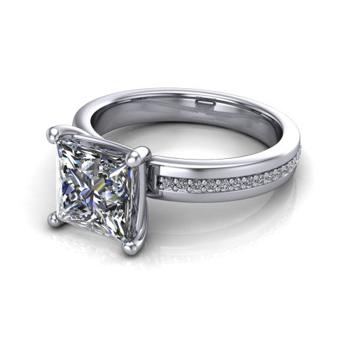 Kamala princess classic solitaire engagement ring in 18K White Gold, three-quarter perspective showing the princess center on claw prongs above a wide channel-set pav&eacute; band