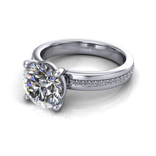 Kamala round classic solitaire engagement ring in Platinum, three-quarter perspective showing the round center on claw prongs above a wide channel-set pav&eacute; band