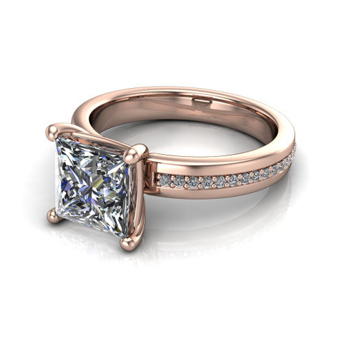 Kamala princess classic solitaire engagement ring in 18K Rose Gold, three-quarter perspective showing the princess center on claw prongs above a wide channel-set pav&eacute; band