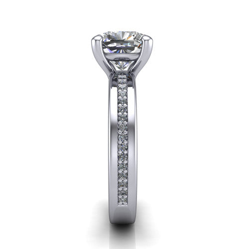 Kamala cushion classic solitaire engagement ring in Platinum, side profile showing the wide channel-set pav&eacute; band with high-polish edges and the open basket