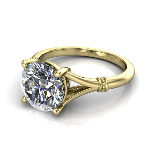Luna round classic solitaire engagement ring in 18K Yellow Gold, three-quarter perspective showing the round center on claw prongs above a plain split shank with pav&eacute; accent collars