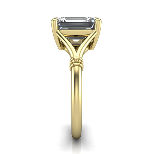 Luna emerald classic solitaire engagement ring in 18K Yellow Gold, side profile showing the plain split shank with pav&eacute; accent collars rising to the emerald center