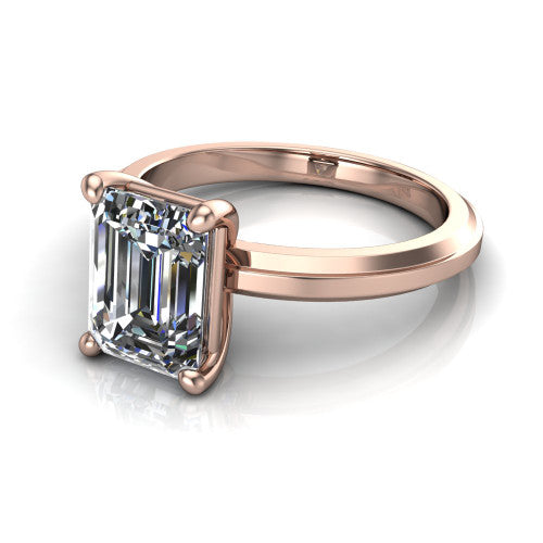 Ellie emerald classic solitaire engagement ring in 18K Rose Gold, three-quarter perspective showing the emerald center on claw prongs above a wide flat knife-edge band