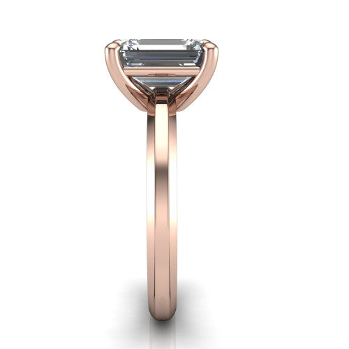 Ellie emerald classic solitaire engagement ring in 18K Rose Gold, side profile showing the substantial knife-edge band and the open basket beneath the emerald center