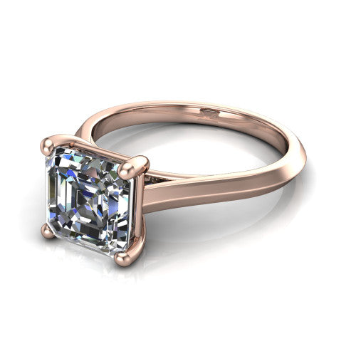 Gianna emerald classic solitaire engagement ring in 14K Rose Gold, three-quarter perspective showing the emerald center on claw prongs above a plain knife-edge band