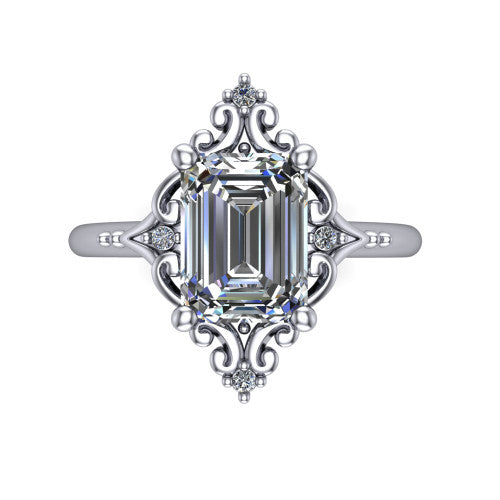 Hazel emerald vintage filigree engagement ring in Platinum, top-down view showing the vintage scrollwork frame and corner diamond accents around the emerald center