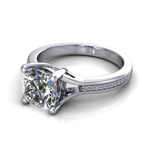 Isla cushion classic solitaire engagement ring in Platinum, three-quarter perspective showing the cushion center on claw prongs above a channel-set pav&eacute; split shank