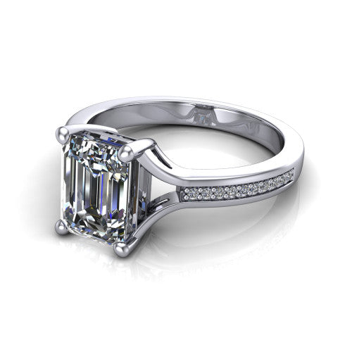 Isla emerald classic solitaire engagement ring in 14K White Gold, three-quarter perspective showing the emerald center on claw prongs above a channel-set pav&eacute; split shank