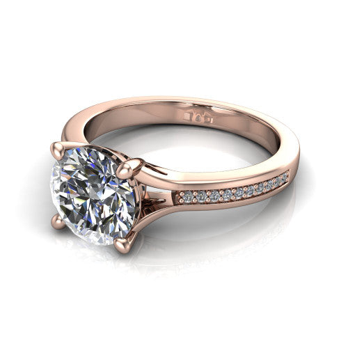 Isla round classic solitaire engagement ring in 18K Rose Gold, three-quarter perspective showing the round center on claw prongs above a channel-set pav&eacute; split shank