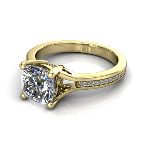 Isla cushion classic solitaire engagement ring in 18K Yellow Gold, three-quarter perspective showing the cushion center on claw prongs above a channel-set pav&eacute; split shank