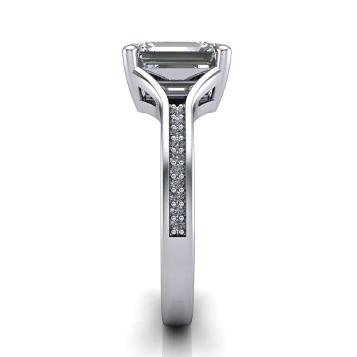 Isla emerald classic solitaire engagement ring in 14K White Gold, side profile showing the channel-set pav&eacute; split shank with polished edges rising to the emerald center