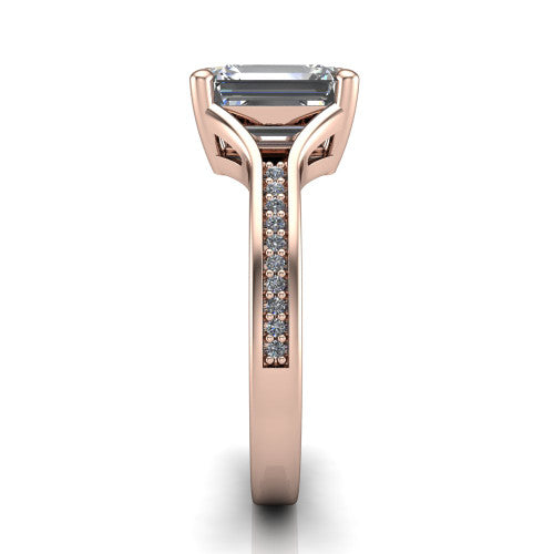 Isla emerald classic solitaire engagement ring in 18K Rose Gold, side profile showing the channel-set pav&eacute; split shank with polished edges rising to the emerald center