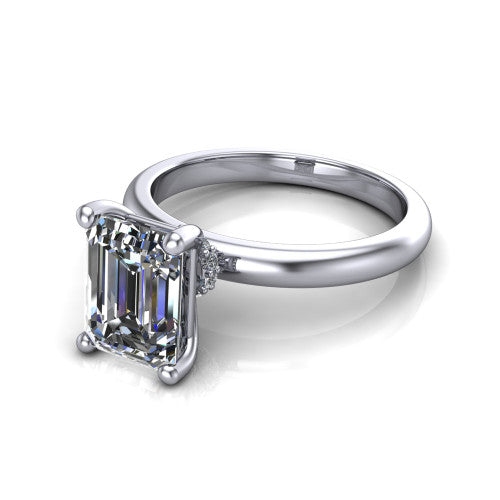 Delilah emerald hidden halo engagement ring in 18K White Gold, three-quarter perspective showing the emerald center on claw prongs above a plain band with a hidden pav&eacute; halo