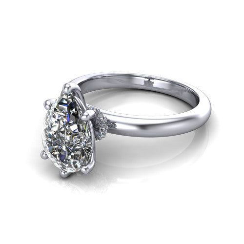 Delilah pear hidden halo engagement ring in 18K White Gold, three-quarter perspective showing the pear center on claw prongs above a plain band with a hidden pav&eacute; halo