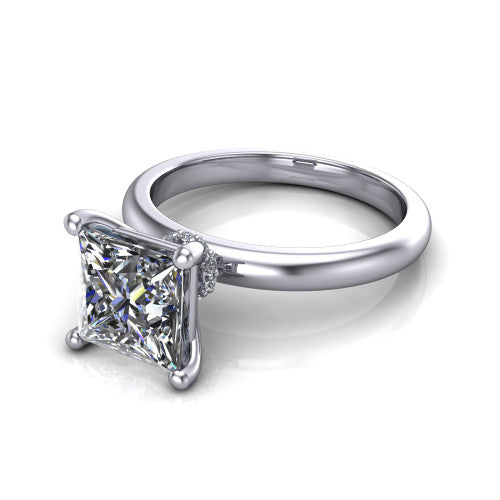 Delilah princess hidden halo engagement ring in 14K White Gold, three-quarter perspective showing the princess center on claw prongs above a plain band with a hidden pav&eacute; halo