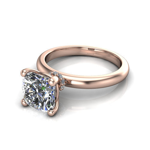 Delilah cushion hidden halo engagement ring in 18K Rose Gold, three-quarter perspective showing the cushion center on claw prongs above a plain band with a hidden pav&eacute; halo