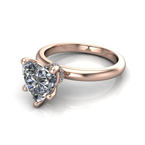 Delilah heart hidden halo engagement ring in 18K Rose Gold, three-quarter perspective showing the heart center on claw prongs above a plain band with a hidden pav&eacute; halo
