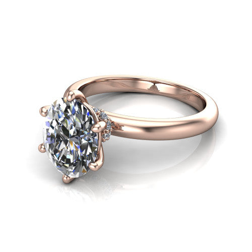 Delilah oval hidden halo engagement ring in 14K Rose Gold, three-quarter perspective showing the oval center on claw prongs above a plain band with a hidden pav&eacute; halo