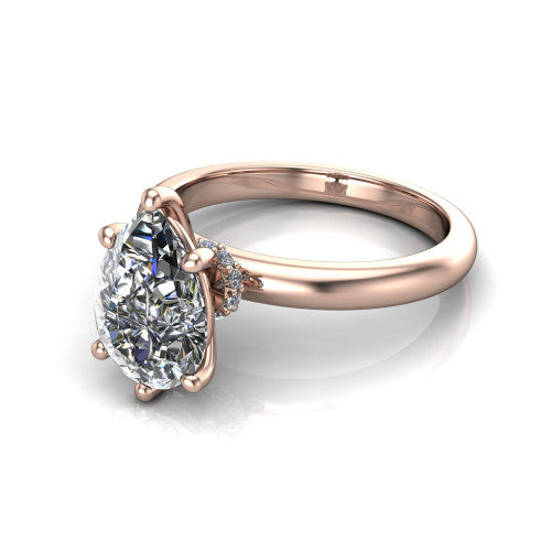 Delilah pear hidden halo engagement ring in 14K Rose Gold, three-quarter perspective showing the pear center on claw prongs above a plain band with a hidden pav&eacute; halo