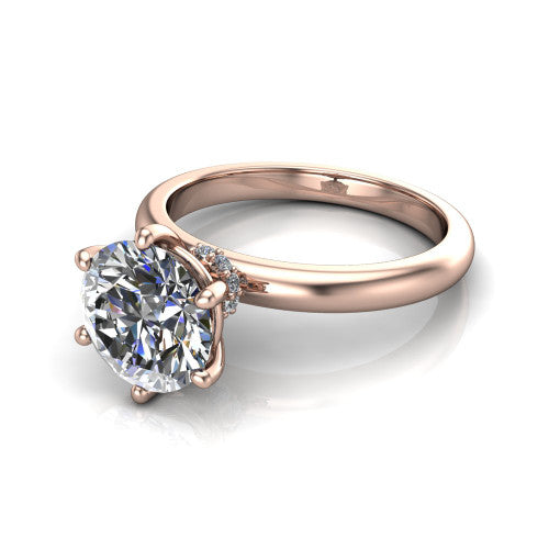 Delilah round hidden halo engagement ring in 14K Rose Gold, three-quarter perspective showing the round center on claw prongs above a plain band with a hidden pav&eacute; halo