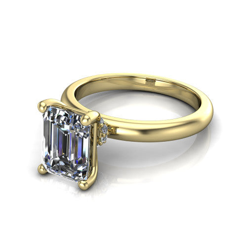 Delilah emerald hidden halo engagement ring in 14K Yellow Gold, three-quarter perspective showing the emerald center on claw prongs above a plain band with a hidden pav&eacute; halo