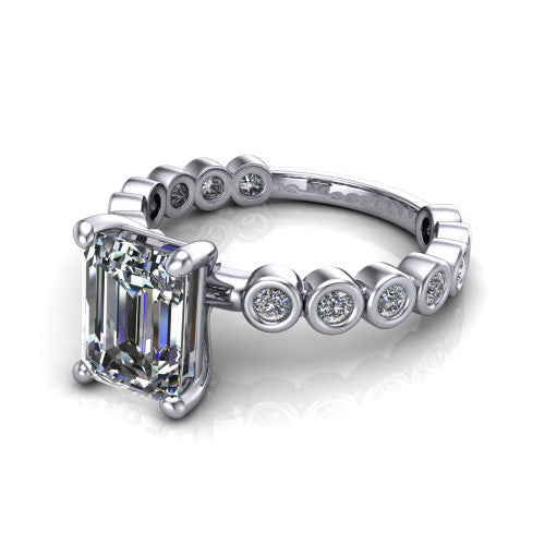 Kinsley emerald solitaire engagement ring in Platinum with bezel-set diamond accent band, three-quarter perspective view
