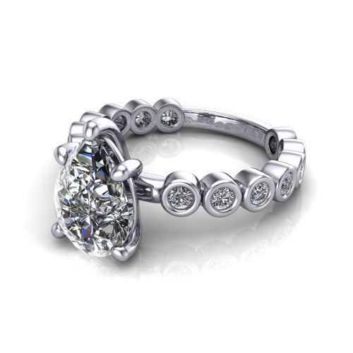 Kinsley pear solitaire engagement ring in Platinum with bezel-set diamond accent band, three-quarter perspective view