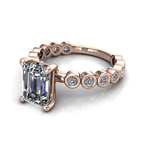 Kinsley emerald solitaire engagement ring in 18K Rose Gold with bezel-set diamond accent band, three-quarter perspective view
