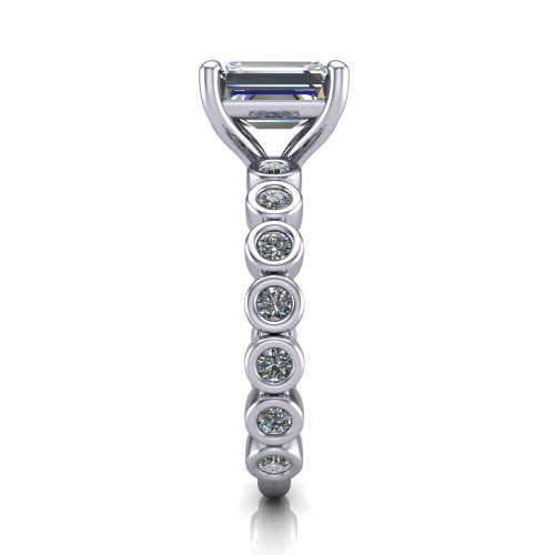 Kinsley emerald solitaire engagement ring in 18K White Gold with bezel-set diamond accent band, side profile showing the bezel-set diamond shank