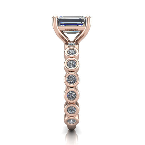 Kinsley emerald solitaire engagement ring in 14K Rose Gold with bezel-set diamond accent band, side profile showing the bezel-set diamond shank