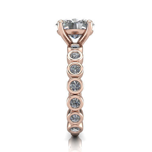 Kinsley oval solitaire engagement ring in 18K Rose Gold with bezel-set diamond accent band, side profile showing the bezel-set diamond shank