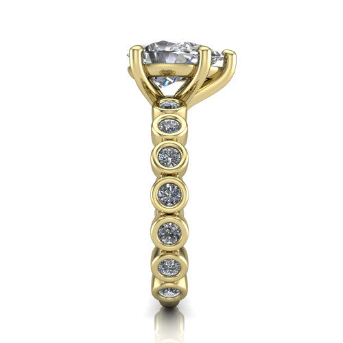 Kinsley pear solitaire engagement ring in 18K Yellow Gold with bezel-set diamond accent band, side profile showing the bezel-set diamond shank