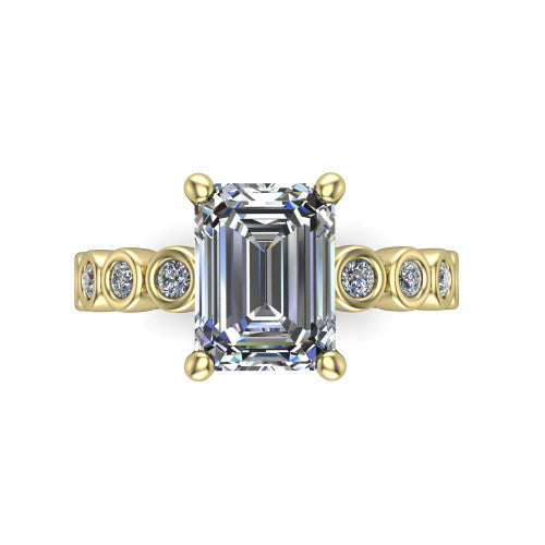Kinsley emerald solitaire engagement ring in 14K Yellow Gold with bezel-set diamond accent band, top-down view of the center stone and bezel band
