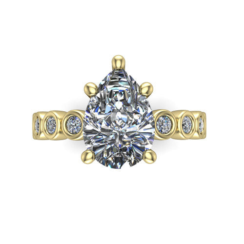 Kinsley pear solitaire engagement ring in 14K Yellow Gold with bezel-set diamond accent band, top-down view of the center stone and bezel band