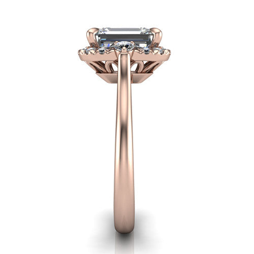 Riley emerald halo engagement ring in 14K Rose Gold with squared pavé halo and round side accents, side profile showing the plain cathedral band and openwork gallery